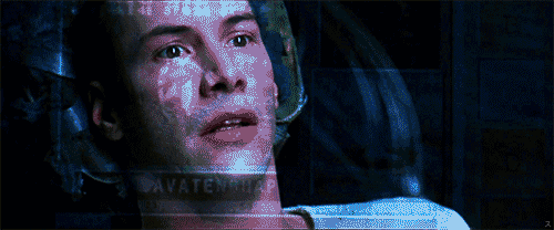 A man sits looking amazed as data is transmitted directly to his brain